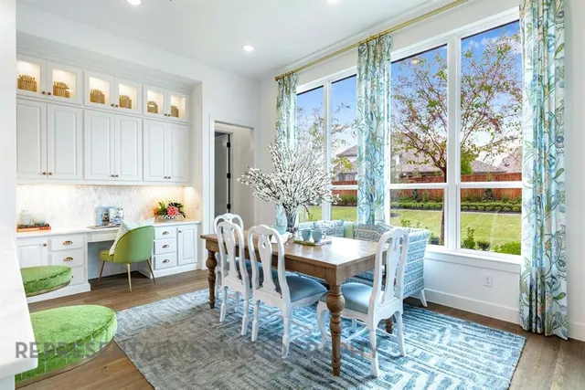 a view of a dining room with furniture window and wooden floor