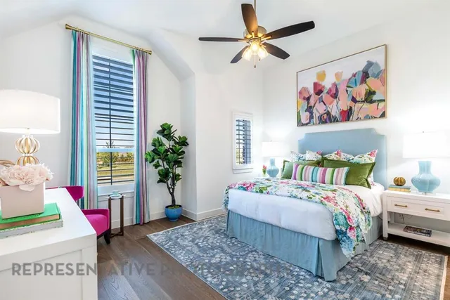 a bedroom with a bed a dresser and a painting on the wall