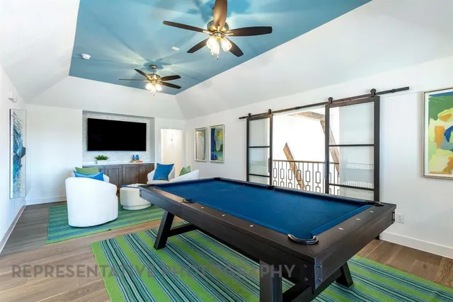 a living room with dining room and flat screen tv