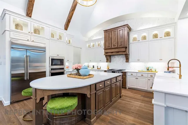 a kitchen with a stove a sink and a refrigerator