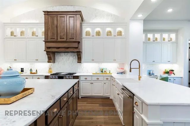 a kitchen with kitchen island granite countertop a sink a counter space and cabinets