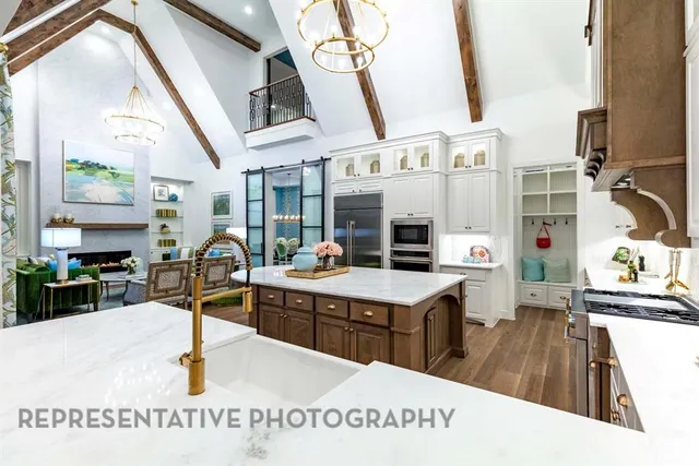 a kitchen with stainless steel appliances kitchen island granite countertop a sink a counter space and cabinets