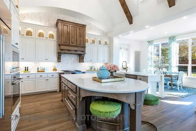 a kitchen with a table chairs sink and cabinets