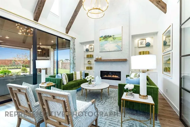 a living room with furniture fireplace and a large window