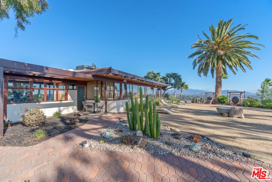 17728 Ridgeway Road Granada Hills, CA 91344 - Photo 8 of 18 a view of a house with a yard and sitting area