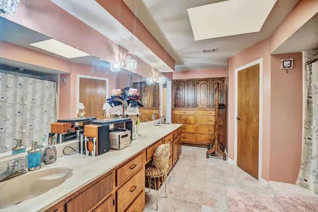 a kitchen with counter top space and wooden floor