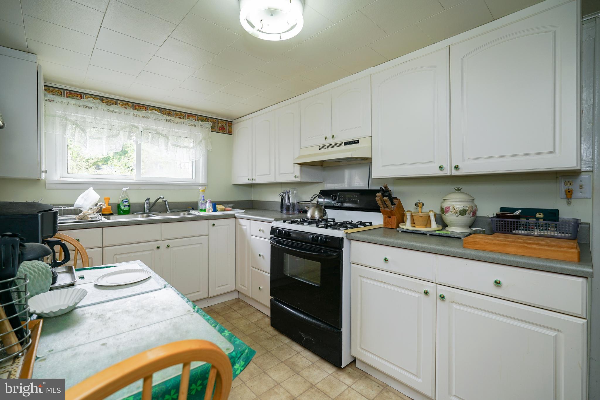 128 Woolens Road Elkton, MD 21921 - Photo 19 of 23 a kitchen with stainless steel appliances granite countertop a sink dishwasher stove and white cabinets
