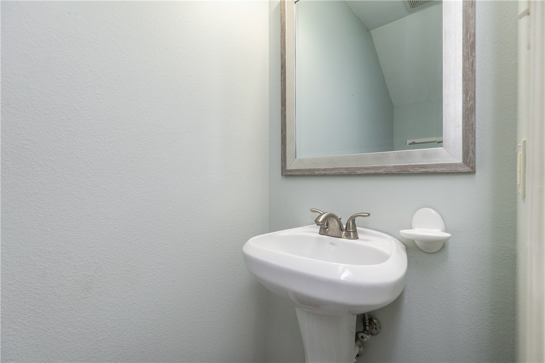 15409 Salt Cay Court, Unit F Corpus Christi, TX 78418 - Photo 14 of 35 a bathroom with a sink and a mirror