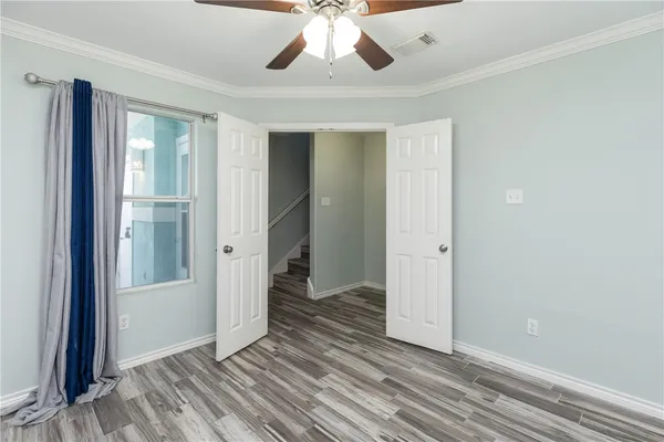 wooden floor in an empty room with a window