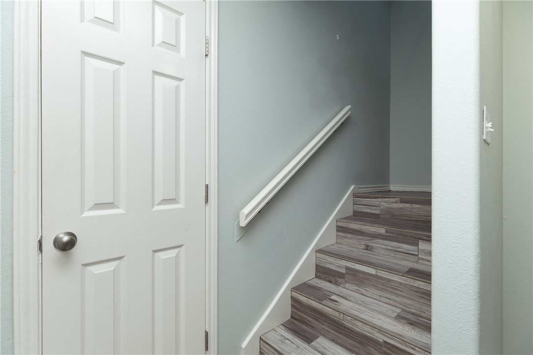15409 Salt Cay Court, Unit F Corpus Christi, TX 78418 - Photo 17 of 35 a view of staircase with railing and white walls
