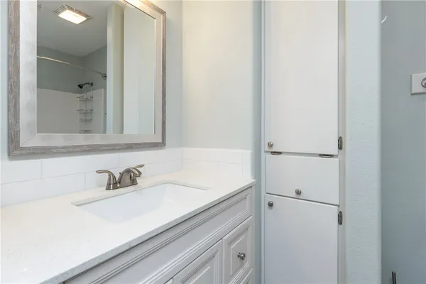 a bathroom with a sink and a mirror