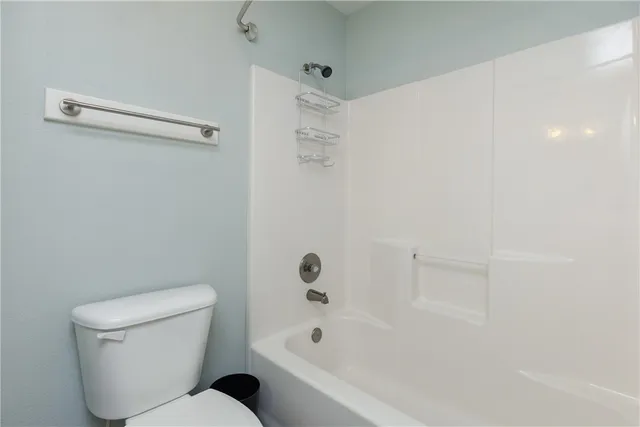 a bathroom with a toilet and a bathtub