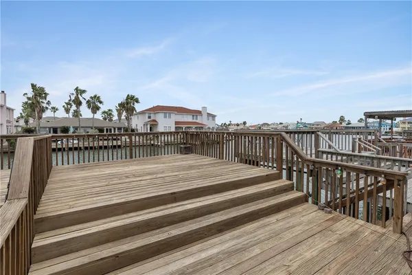 a balcony with wooden floor and city view