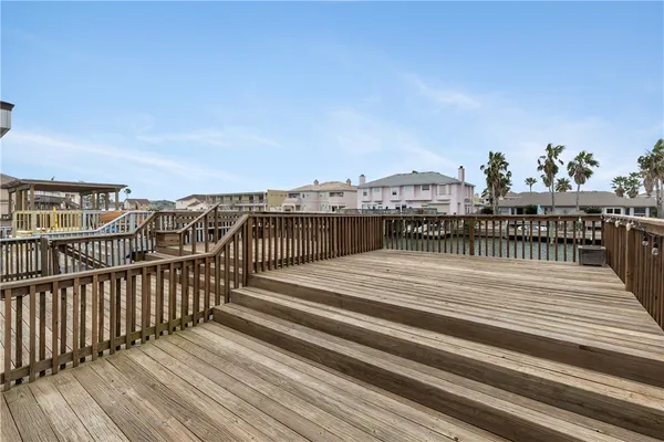 a view of a balcony with wooden floor and city view