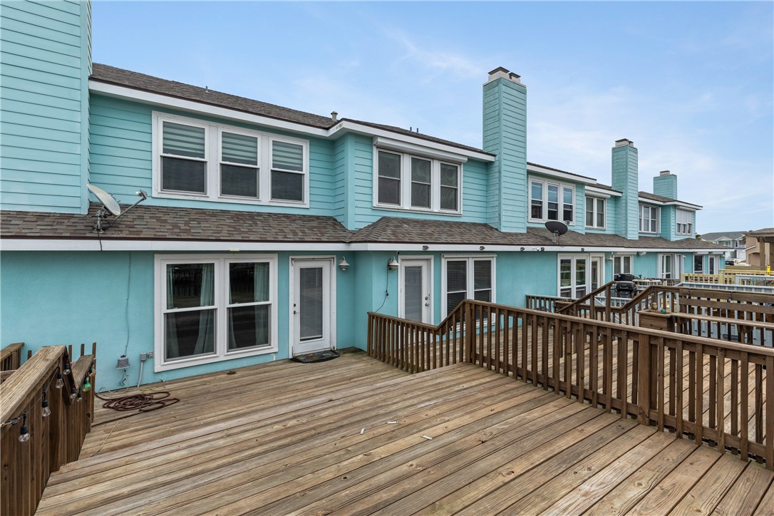 15409 Salt Cay Court, Unit F Corpus Christi, TX 78418 - Photo 31 of 35 a front view of a house with deck