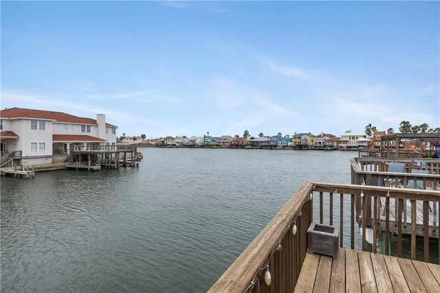 a view of a lake with boats and trees in the background