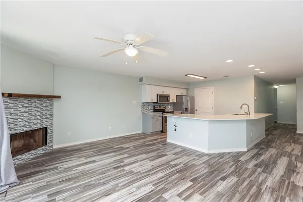 a view of kitchen with cabinets microwave and stove