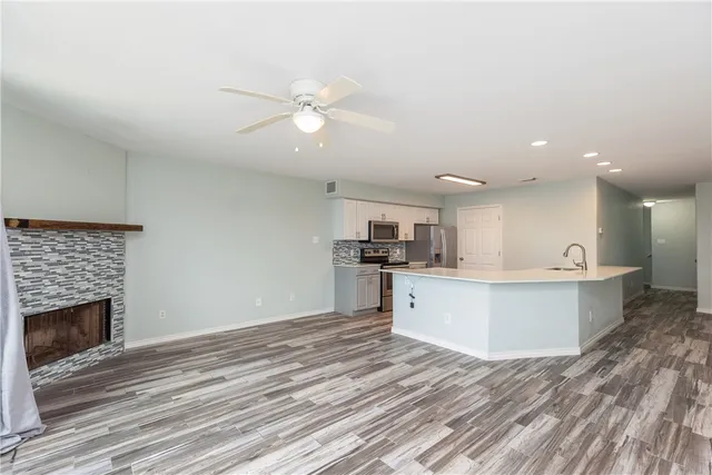 a view of kitchen with cabinets microwave and stove