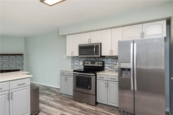 a kitchen with a stove microwave and refrigerator