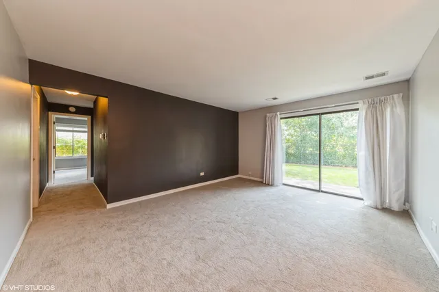 a view of an empty room with glass door
