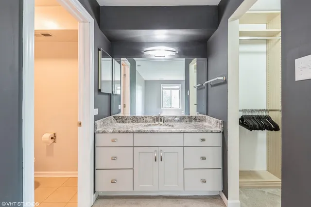 a bathroom with a granite countertop sink a mirror and a