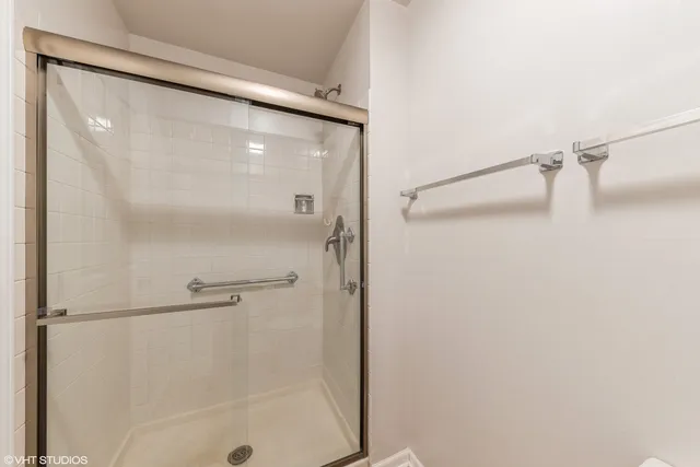a bathroom with a glass shower door