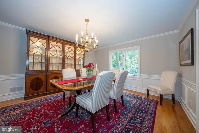 a dining room with furniture a rug and a chandelier