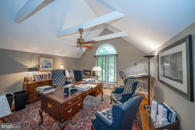 a living room with furniture a ceiling fan and a window