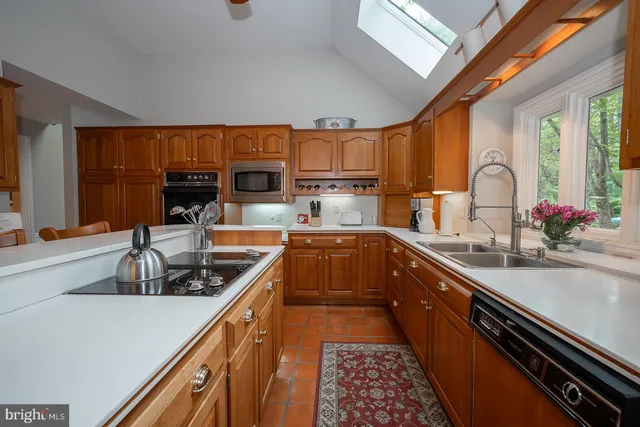 a kitchen with stainless steel appliances a sink stove and cabinets