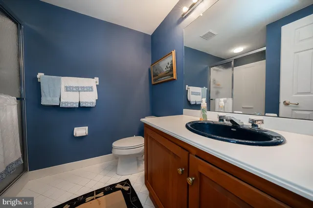 an aerial view of a house with outdoor space and trees all around