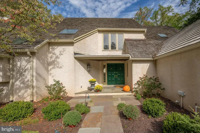 a view of a house with potted plants