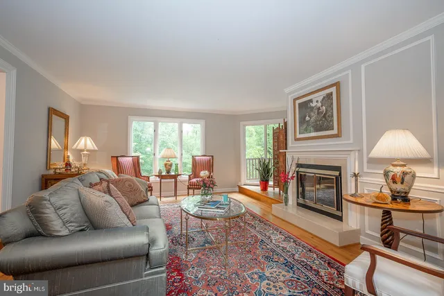 a living room with furniture flat screen tv and a fireplace