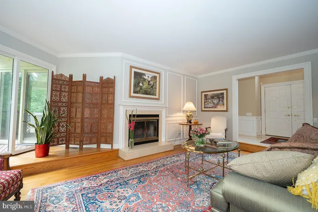 a living room with furniture a rug and a fireplace