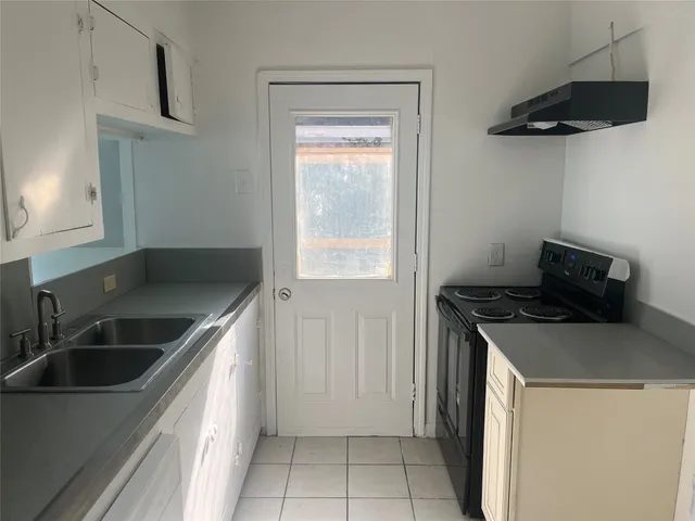 a kitchen that has a sink and a stove