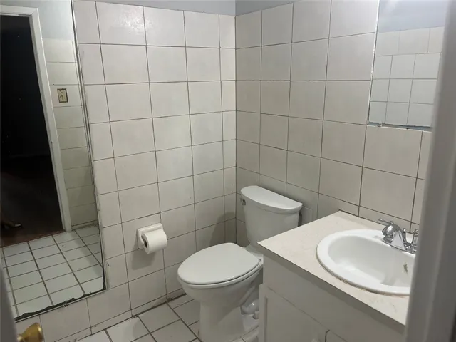 a white toilet sitting next to a bathroom sink