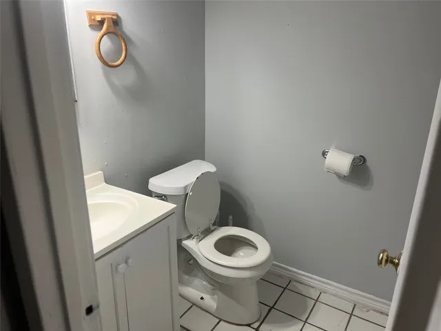 a white toilet sitting next to a white sink and a shower