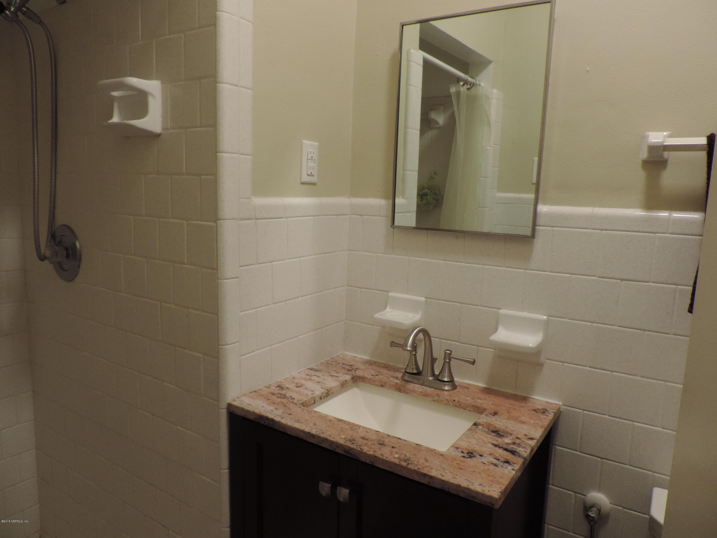 4006 Bess Road Jacksonville, FL 32277 - Photo 21 of 30 a bathroom with a granite countertop sink and a mirror