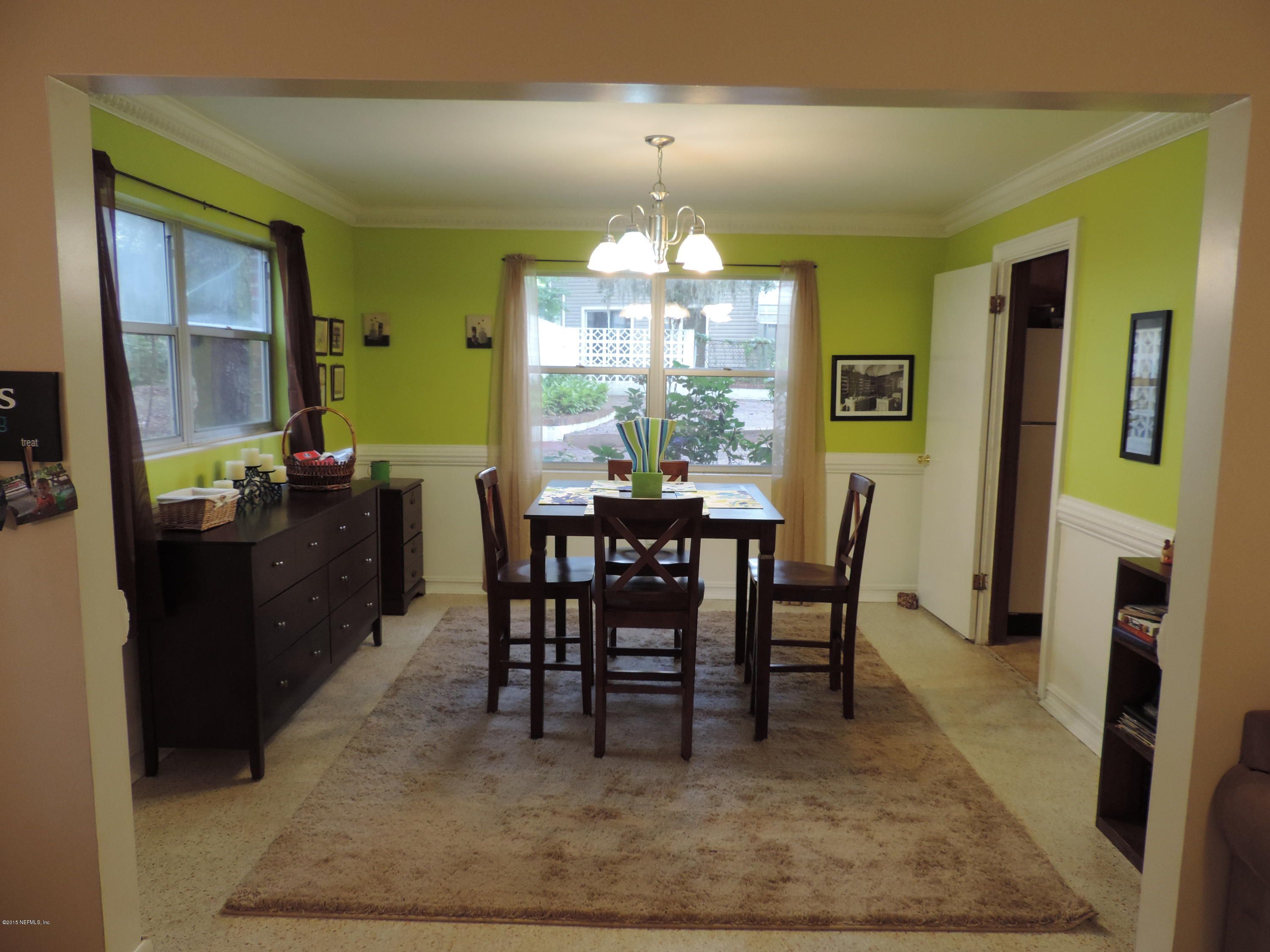 4006 Bess Road Jacksonville, FL 32277 - Photo 6 of 30 a view of a dining room with furniture and a chandelier