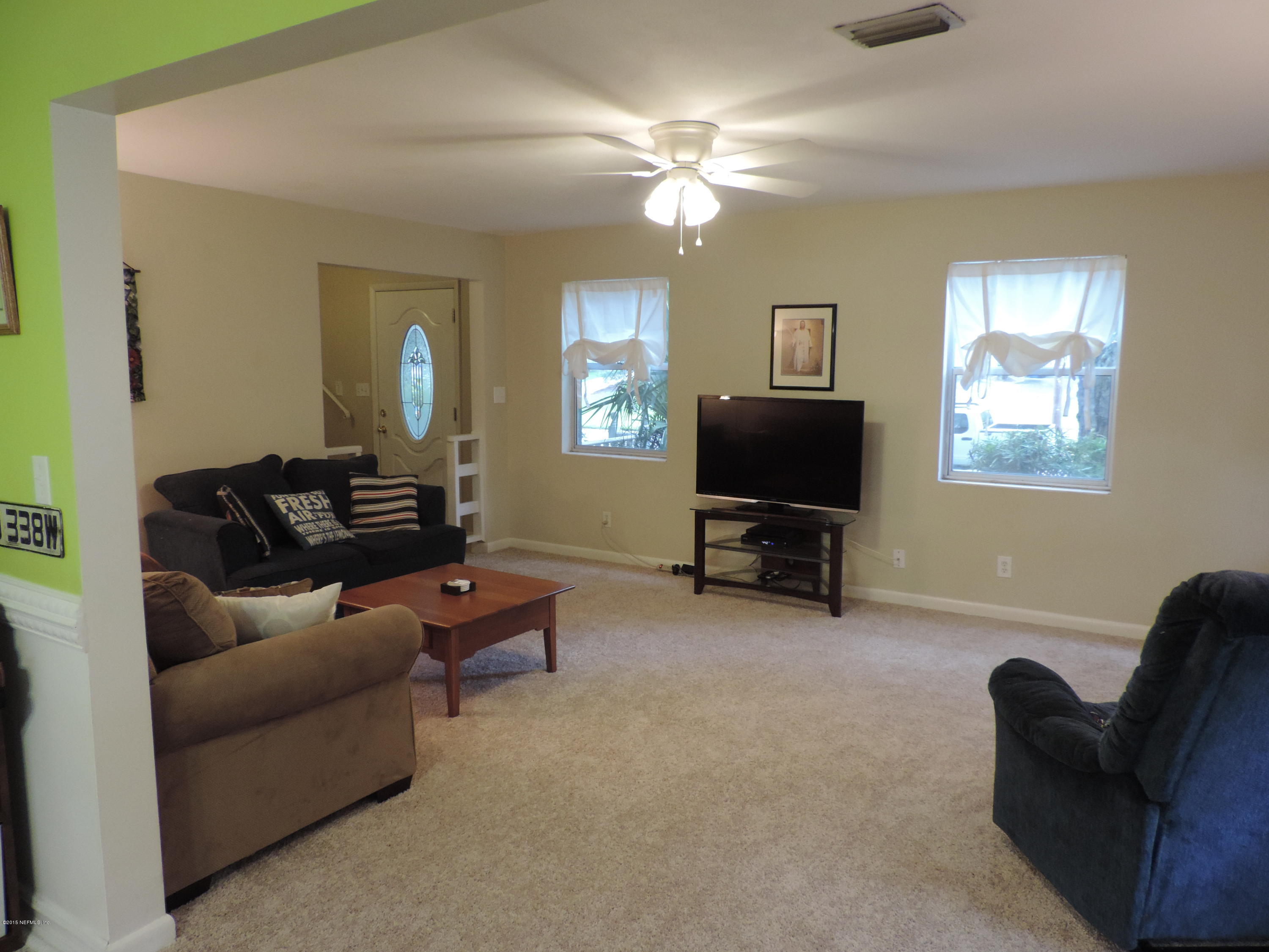 4006 Bess Road Jacksonville, FL 32277 - Photo 7 of 30 a living room with furniture and a flat screen tv