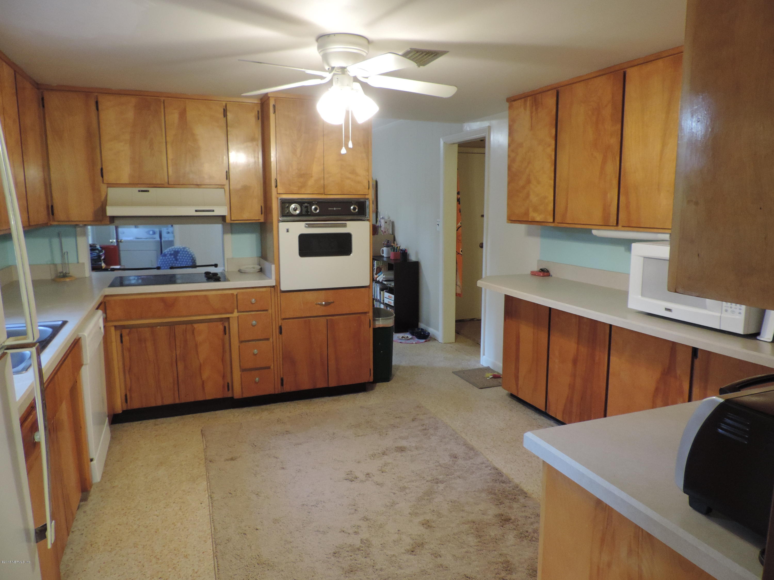 4006 Bess Road Jacksonville, FL 32277 - Photo 8 of 30 a large kitchen with cabinets and stainless steel appliances