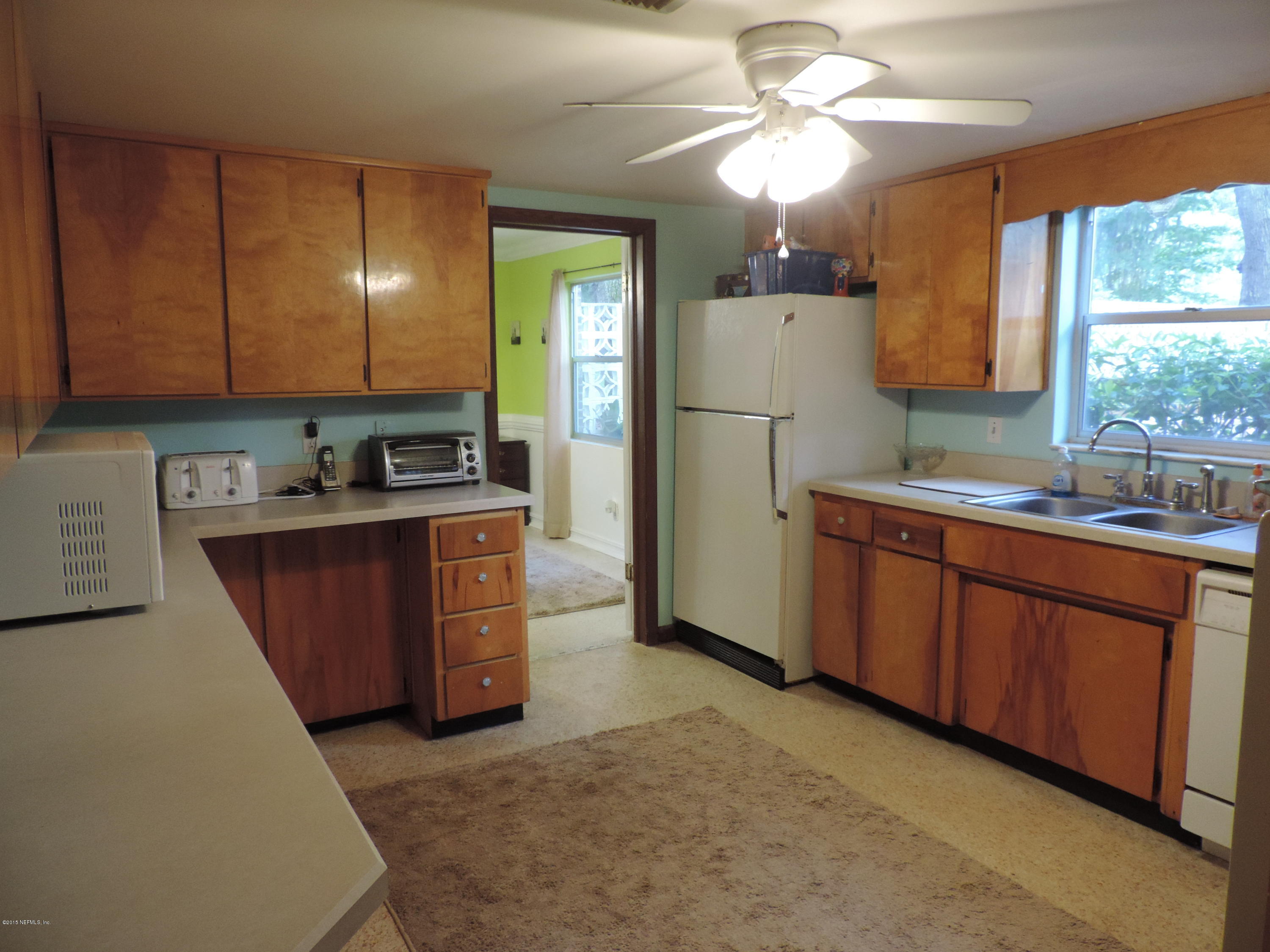 4006 Bess Road Jacksonville, FL 32277 - Photo 9 of 30 a kitchen with stainless steel appliances granite countertop a sink stove and refrigerator