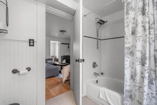a bathroom with a tub and shower