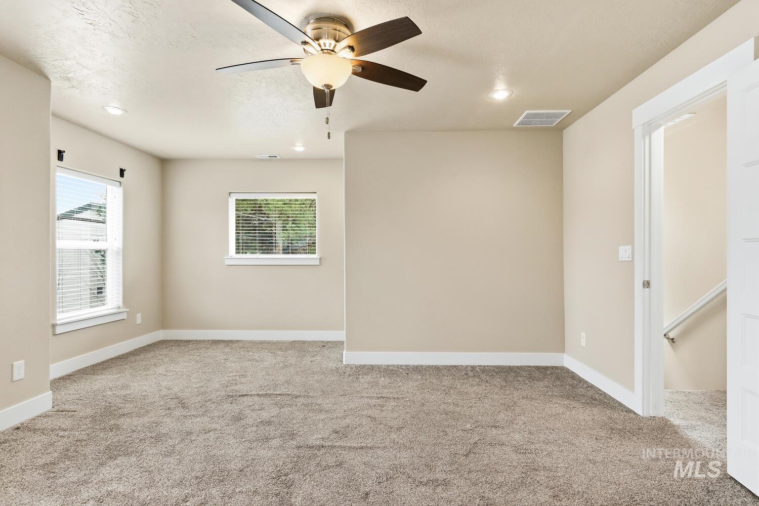 3003 West Moore Street Boise, ID 83702 - Photo 18 of 35 Spare room featuring a ceiling fan, light colored carpet, and recessed lighting