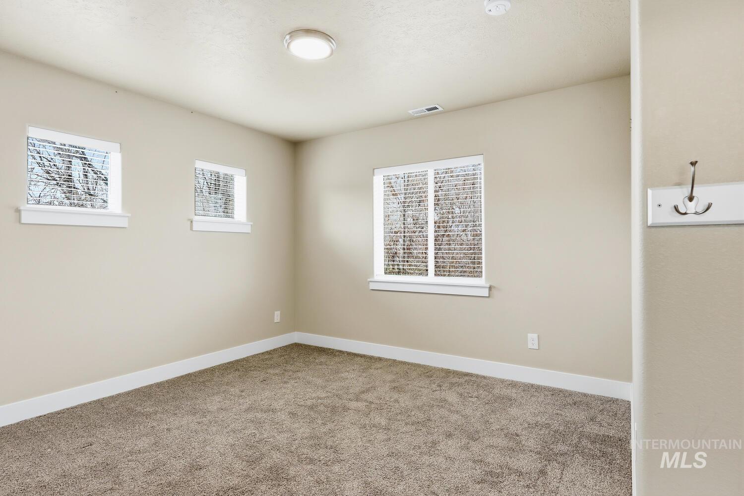 3003 West Moore Street Boise, ID 83702 - Photo 24 of 35 Empty room with carpet and baseboards