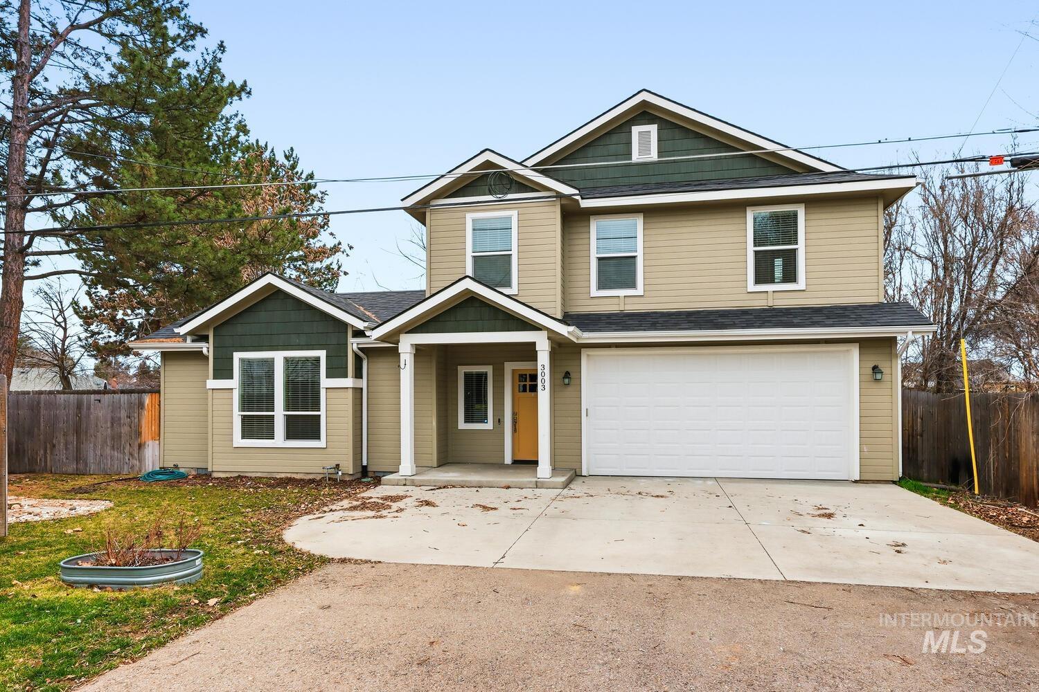 3003 West Moore Street Boise, ID 83702 - Photo 35 of 35 View of front of home featuring covered porch, an attached garage, driveway, and a shingled roof