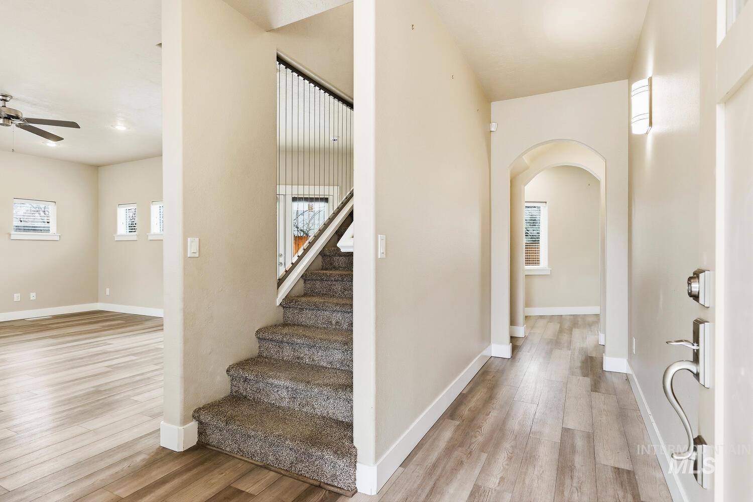 3003 West Moore Street Boise, ID 83702 - Photo 4 of 35 Entrance foyer featuring arched walkways, light wood finished floors, and ceiling fan