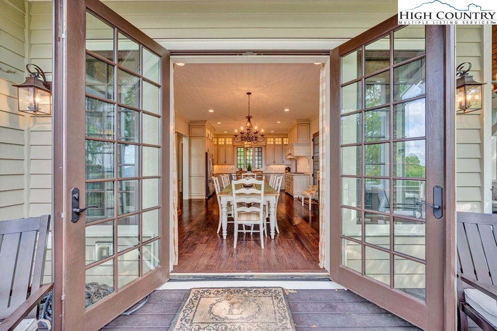 906 Fox Meadow Road Banner Elk, NC 28604 - Photo 11 of 40 a dining room with furniture a chandelier and wooden floor