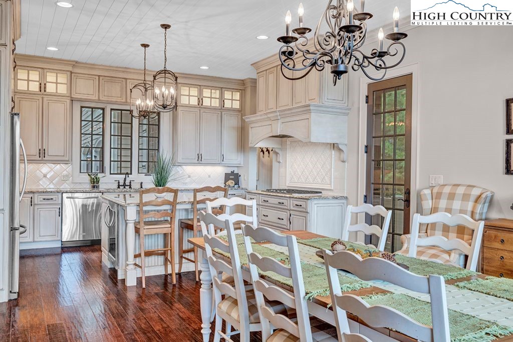 906 Fox Meadow Road Banner Elk, NC 28604 - Photo 12 of 40 a view of a dining room with furniture wooden floor and chandelier