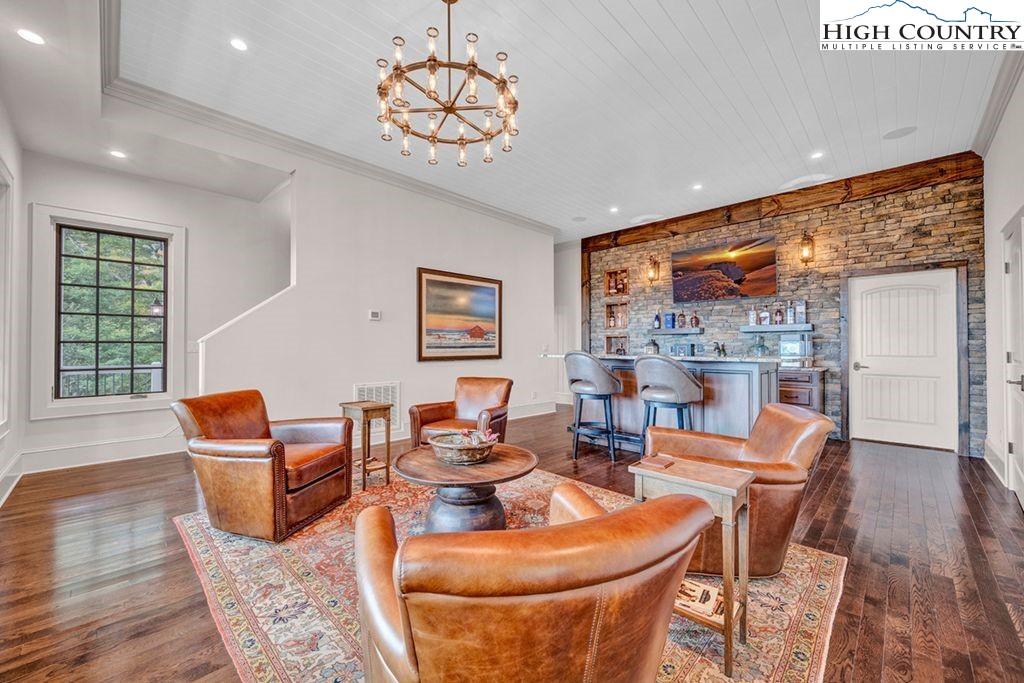 906 Fox Meadow Road Banner Elk, NC 28604 - Photo 27 of 40 a dining room with furniture a rug and wooden floor