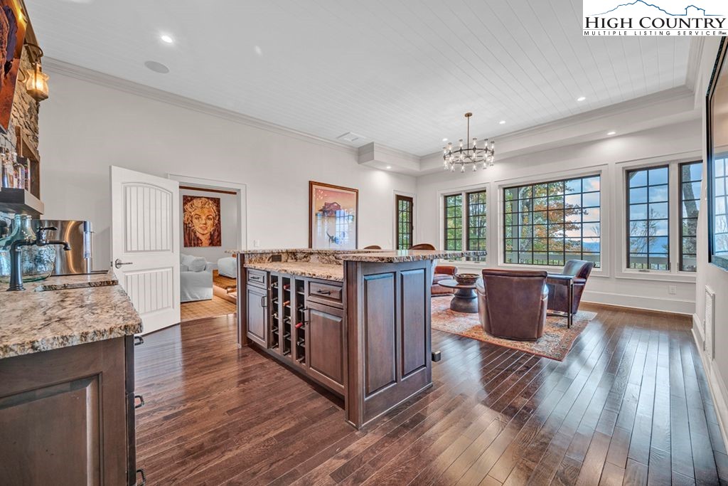 906 Fox Meadow Road Banner Elk, NC 28604 - Photo 28 of 40 a living room with furniture large window and wooden floor
